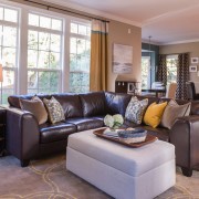 Благородный темный кожаный диван в интерьере гостиной Благородный темный кожаный диван в интерьере гостиной