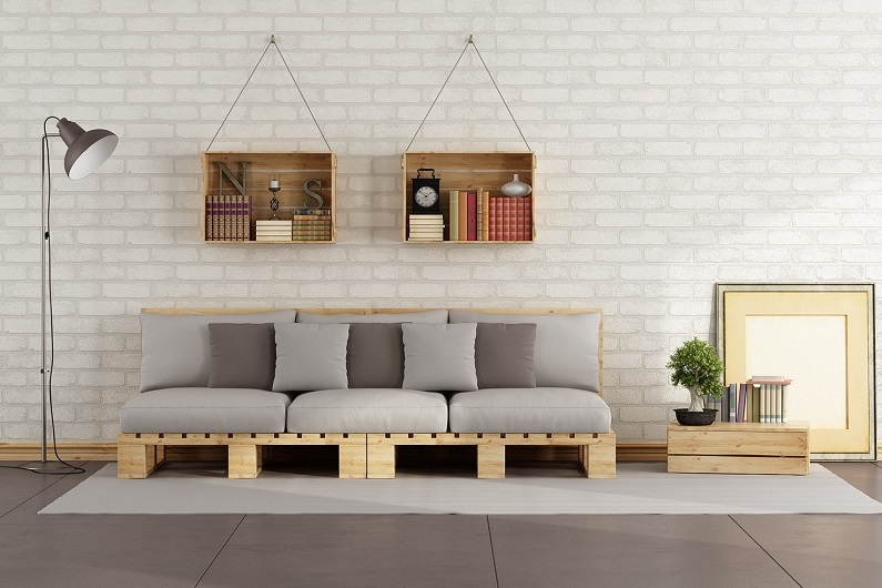 Living room with pallet sofa and wooden crate with books on brick wall - 3D Rendering